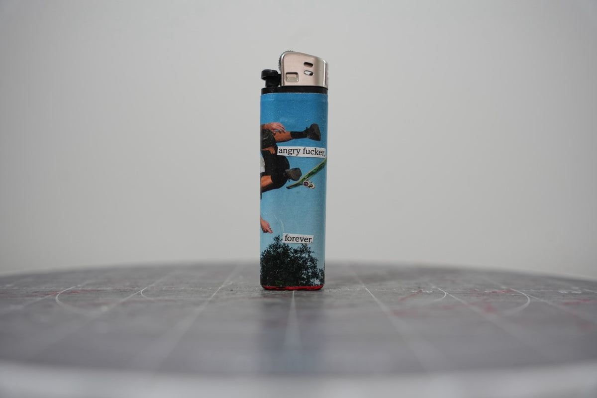 Hand-collaged lighter with sky-blue skate photography and cut-paper text reading "angry f***r." and "forever."