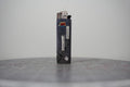 Hand-collaged lighter with navy speckled ground, cut-paper florals and the text "a remarkable gender identity"