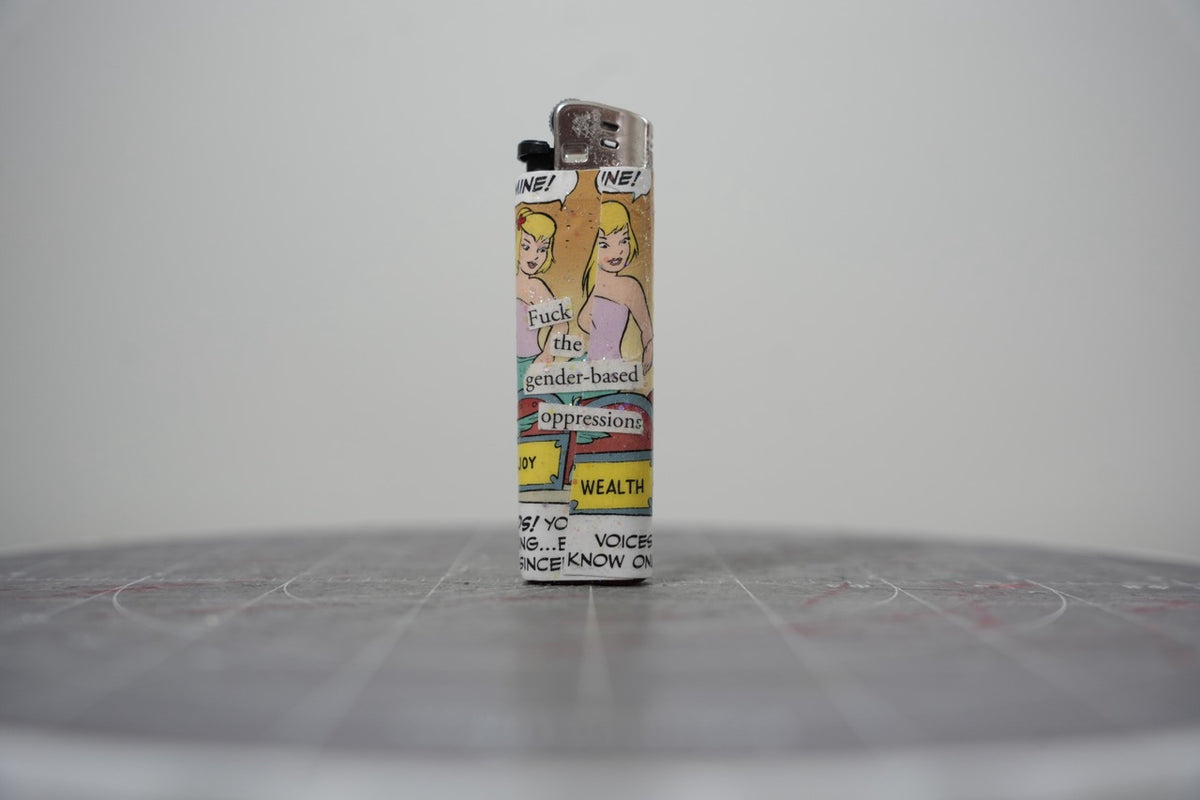 Reverse side of the Disney comic collage lighter reading "f*** the gender-based oppressions"