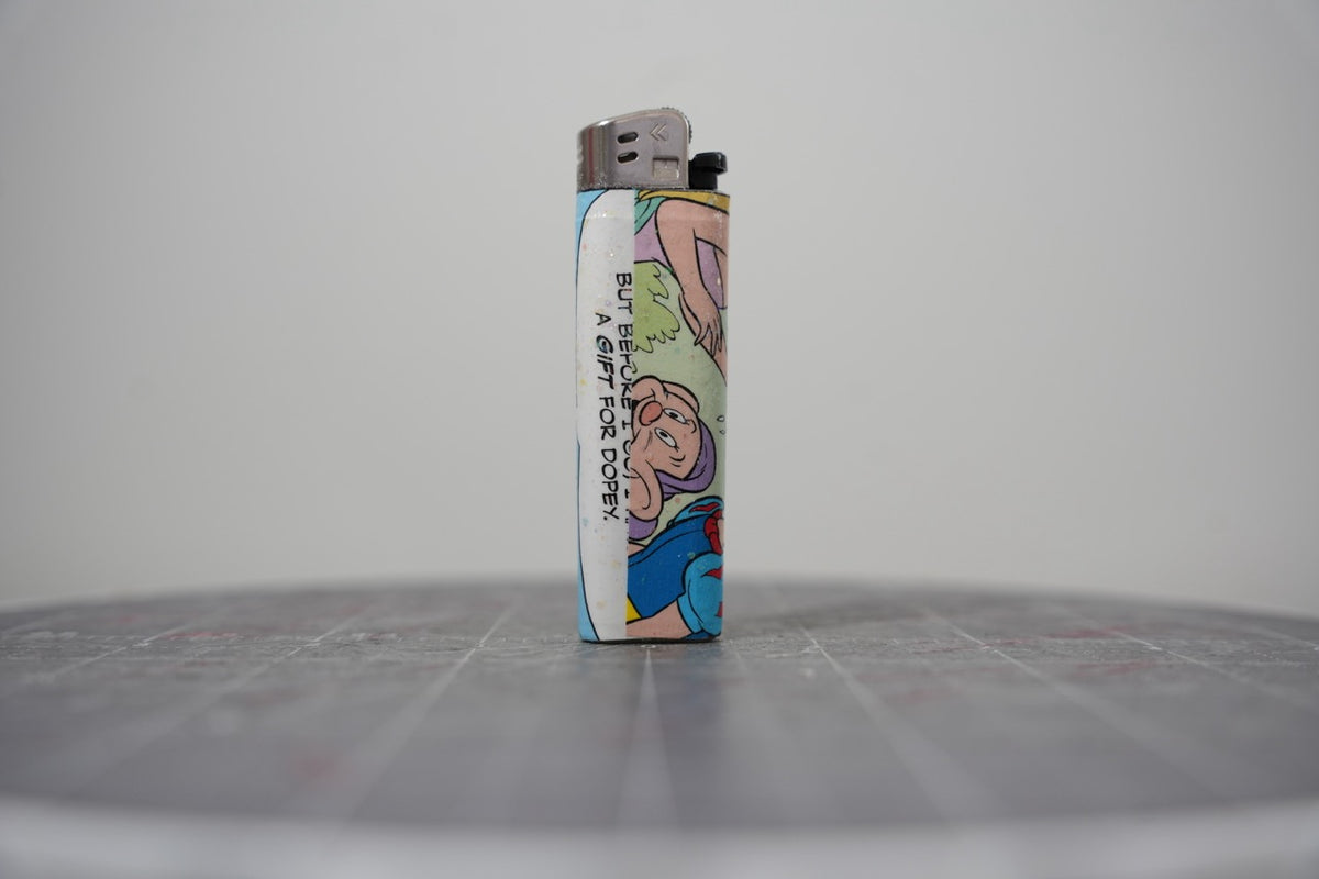 Reverse side of the Disney comic collage lighter reading "but before I go... a gift for Dopey"