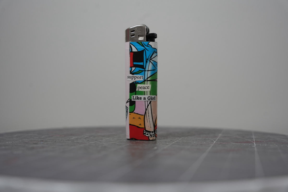 Reverse side of the Disney comic collage lighter reading "support peace Like a Girl"