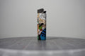 Handmade collage lighter made from vintage Disney comic book paper, Goofy in a striped shirt seeing stars
