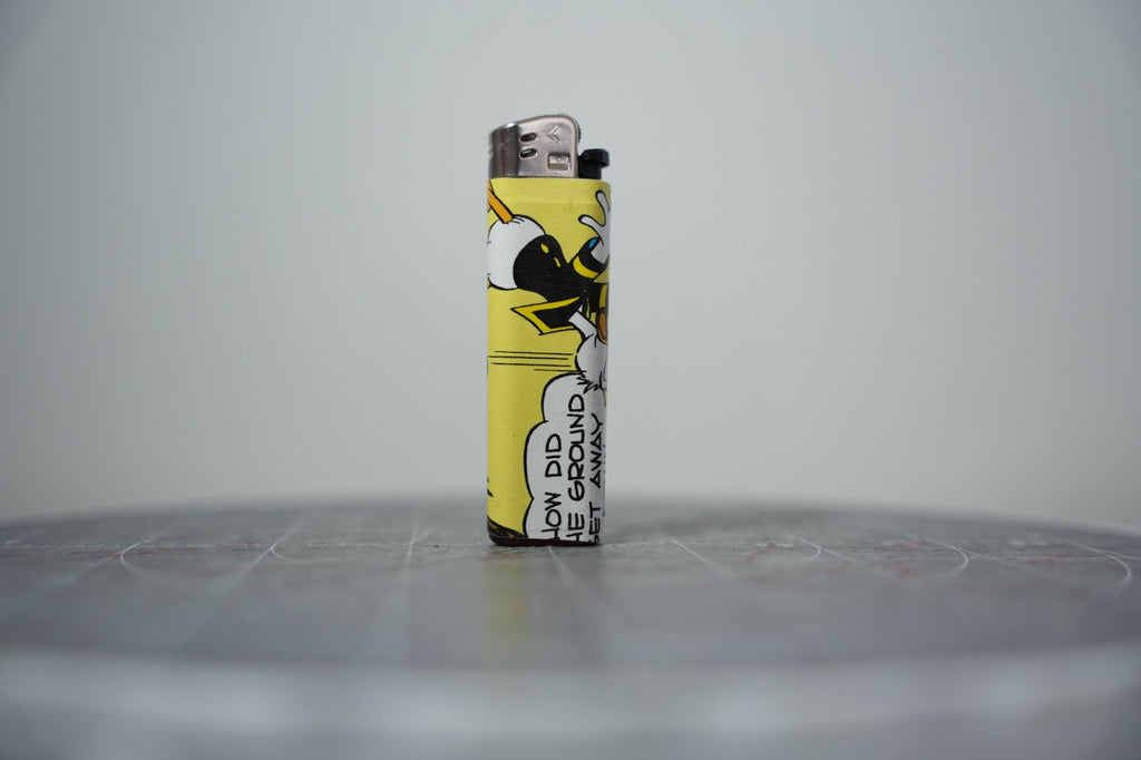 Handmade collage lighter made from vintage Disney comic book paper, Donald Duck falling on a butter yellow ground