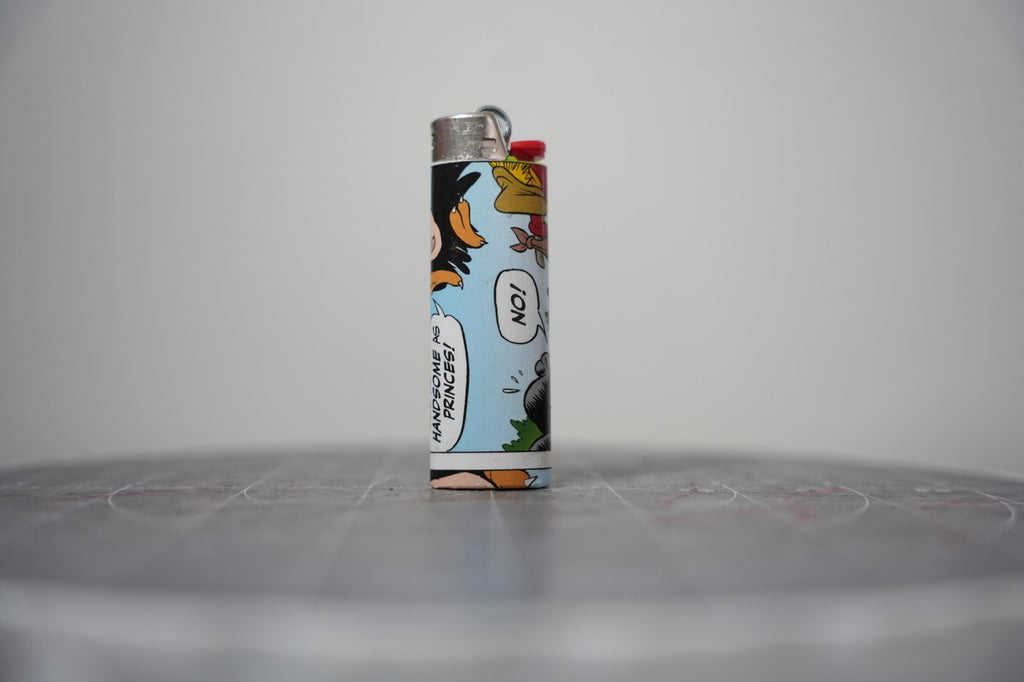 Handmade collage lighter made from vintage Disney comic book paper, the Evil Queen in her crown on sky blue