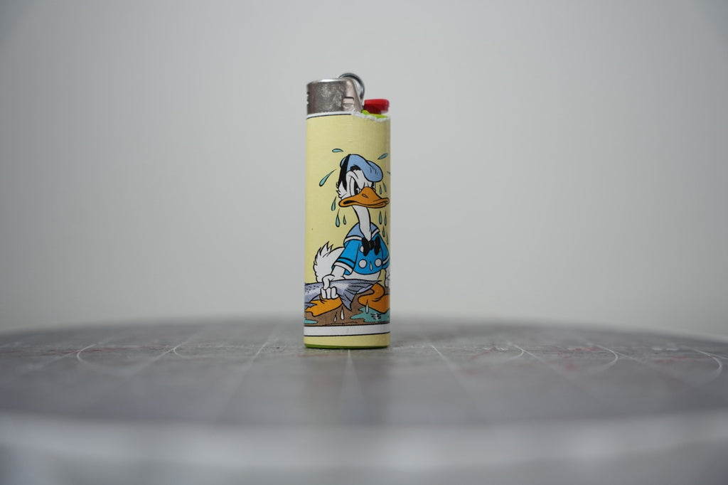 Handmade collage lighter made from vintage Disney comic book paper, Donald Duck crying over a fish
