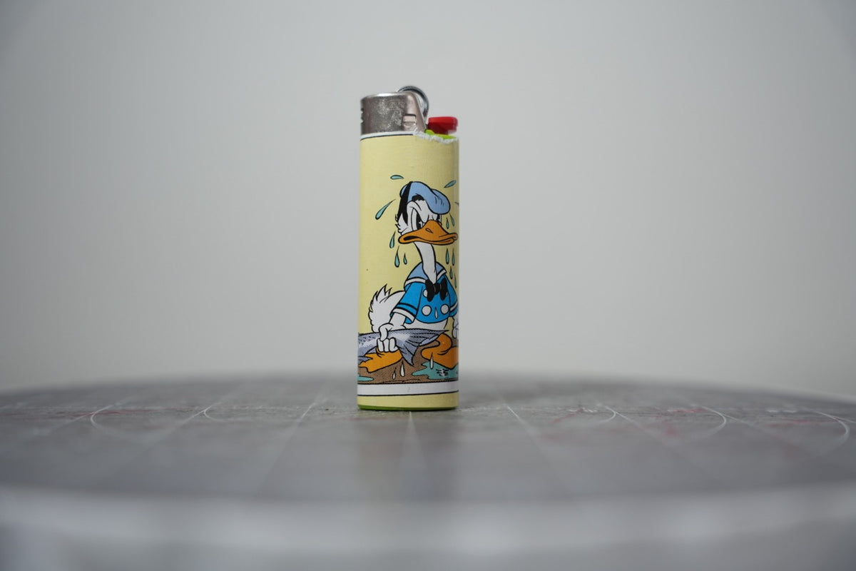 Handmade collage lighter made from vintage Disney comic book paper, Donald Duck crying over a fish