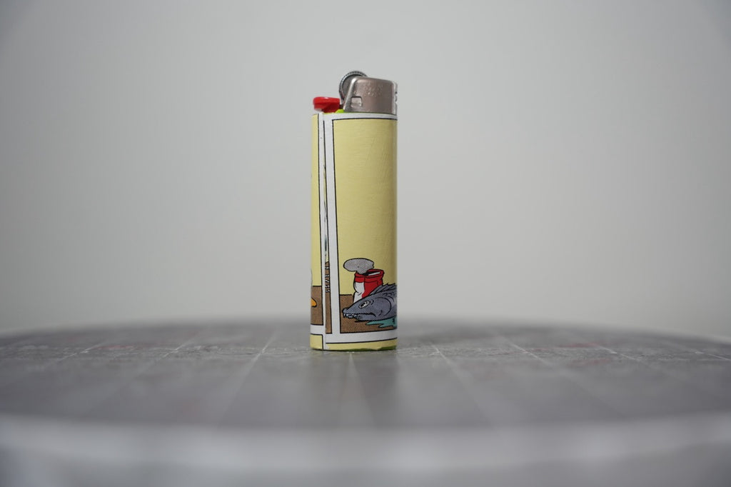 Reverse of the Disney comic book collage lighter showing the fish and a tipped can