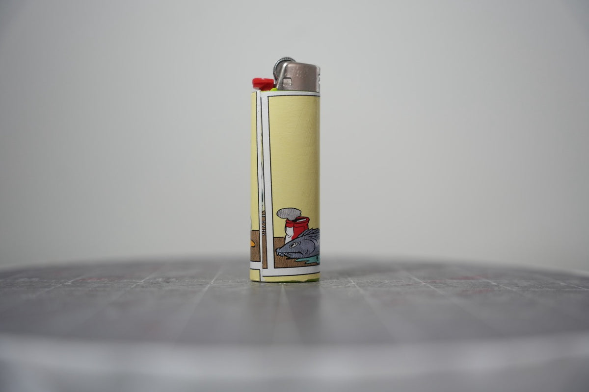 Reverse of the Disney comic book collage lighter showing the fish and a tipped can