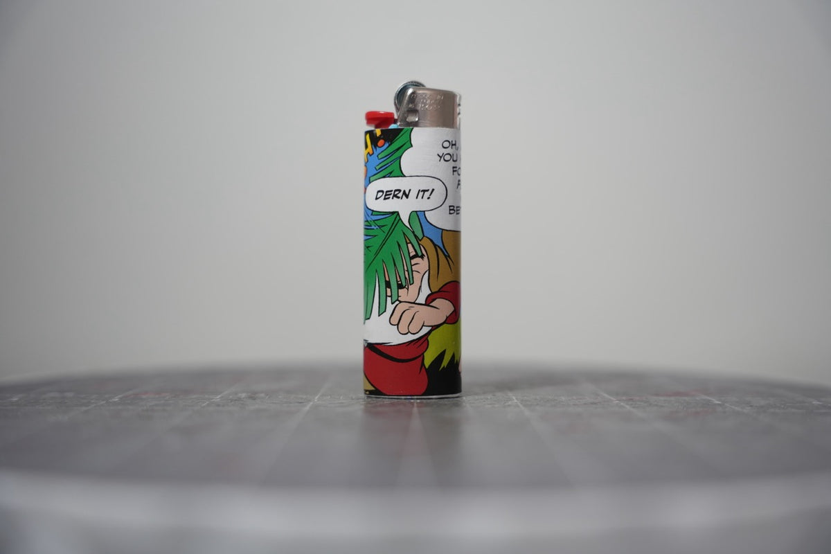 Handmade collage lighter made from vintage Disney comic book paper, a dwarf in a pine tree saying dern it