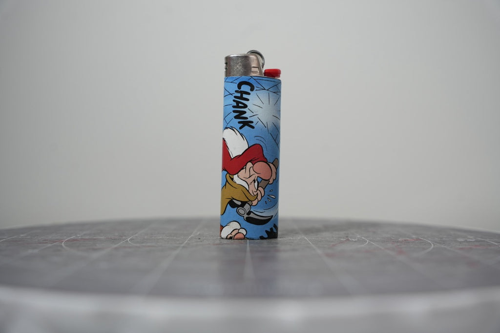 Handmade collage lighter made from vintage Disney comic book paper, Grumpy chopping at a giant cobweb