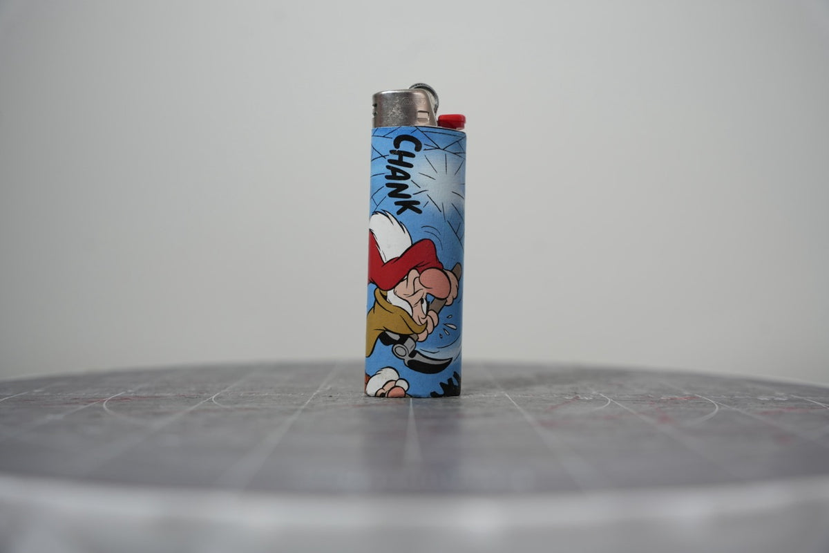 Handmade collage lighter made from vintage Disney comic book paper, Grumpy chopping at a giant cobweb