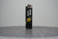 Front of a handmade collage lighter made from vintage Disney comic book paper, glittery black ground with a yellow crown and cut-paper text