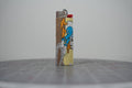 Front of a handmade collage lighter made from vintage Disney comic book paper, Donald Duck with a coil of rope on a yellow glittered ground