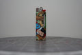 Front of a handmade collage lighter made from vintage Disney comic book paper, with cut-paper text reading enjoying my company