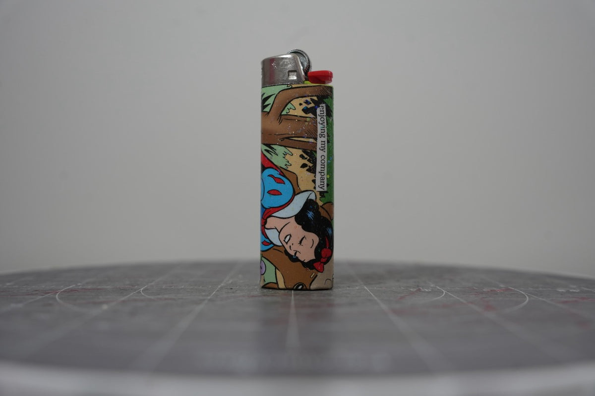 Front of a handmade collage lighter made from vintage Disney comic book paper, with cut-paper text reading enjoying my company
