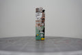 Front of a handmade collage lighter made from vintage Disney comic book paper, cut-paper text reading found belonging in trans people