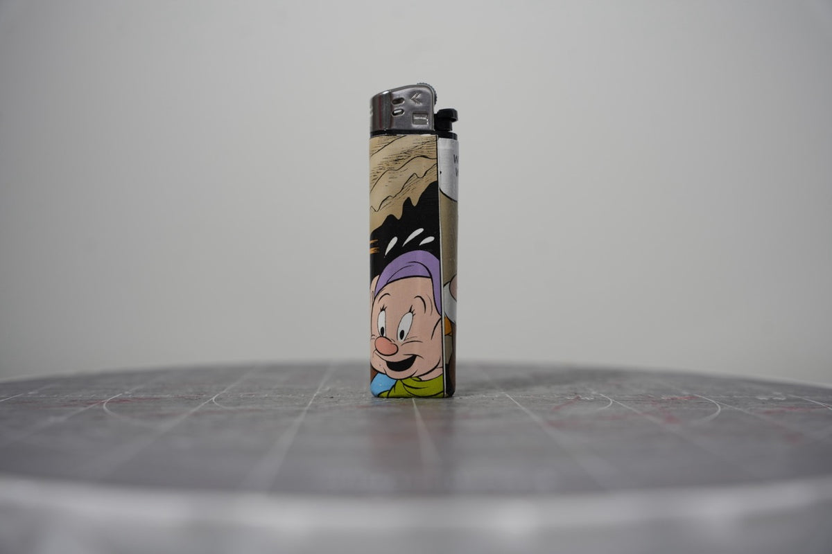 Handmade collage lighter made from vintage Disney comic book paper, Dopey in his purple cap
