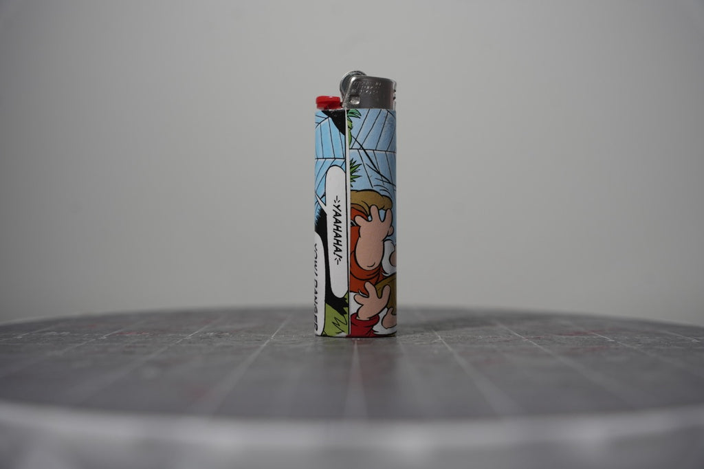 Handmade collage lighter made from vintage Disney comic book paper, hands flailing and the word yaahaha