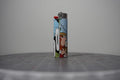 Handmade collage lighter made from vintage Disney comic book paper, hands flailing and the word yaahaha