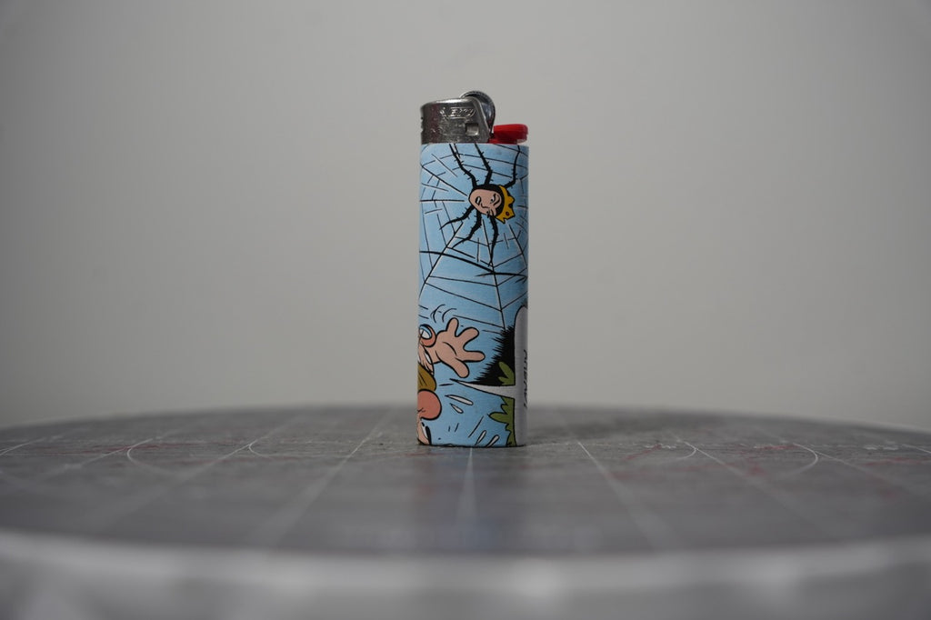 Reverse of the Disney comic book collage lighter showing a spider in a big web