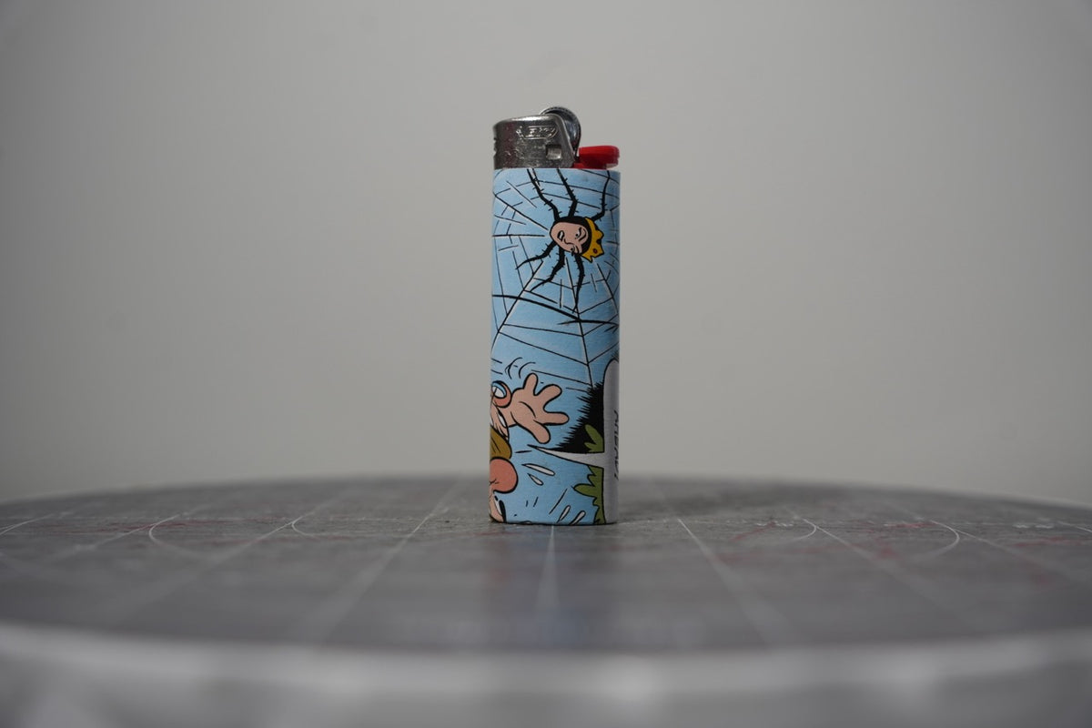 Reverse of the Disney comic book collage lighter showing a spider in a big web