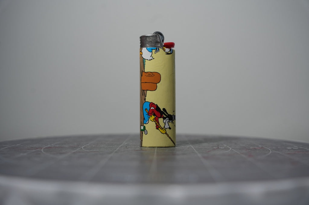 Handmade collage lighter made from vintage Disney comic book paper, Donald and Goofy with a pickaxe