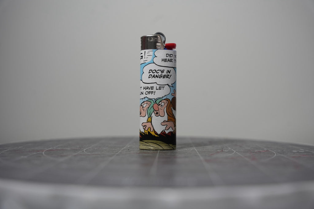 Handmade collage lighter made from vintage Disney comic book paper, worried dwarves and the words doc's in danger