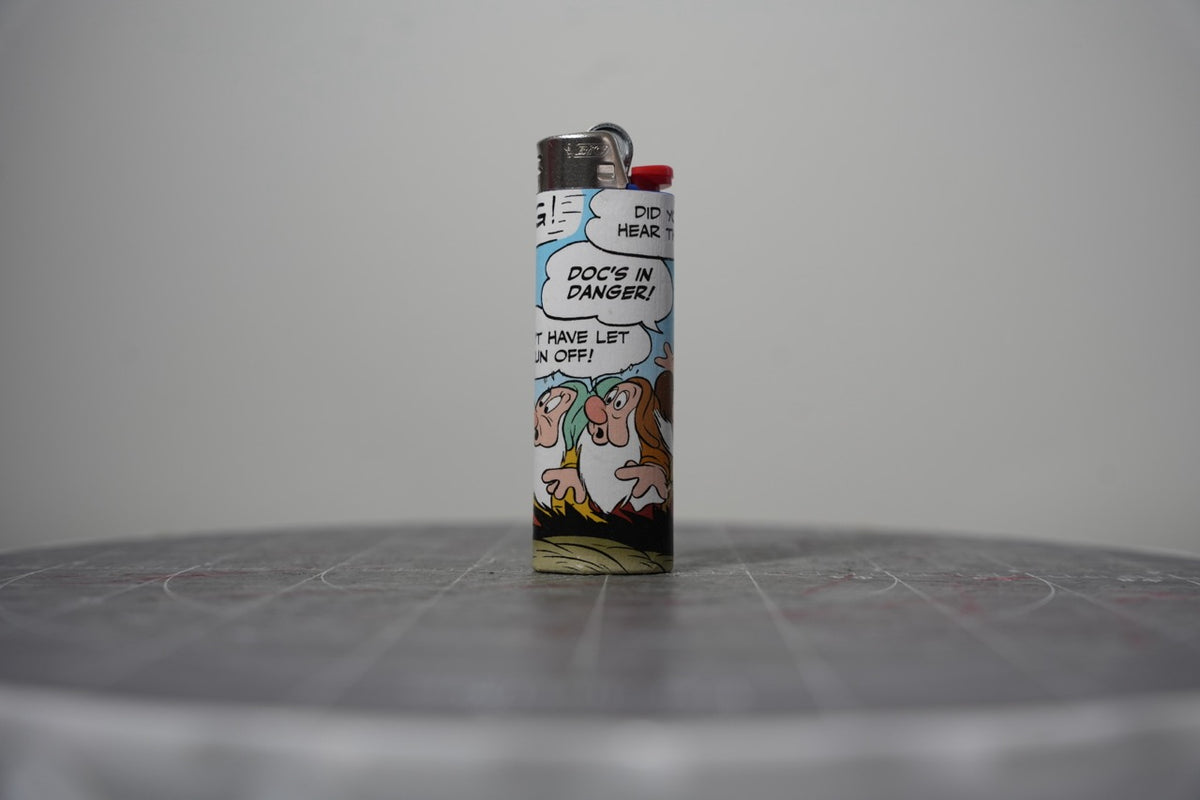 Handmade collage lighter made from vintage Disney comic book paper, worried dwarves and the words doc's in danger