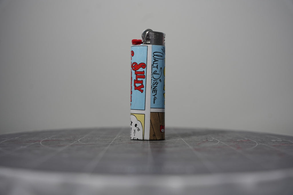 Reverse of the Disney comic book collage lighter showing the Silly Symphonies logo and Walt Disney signature