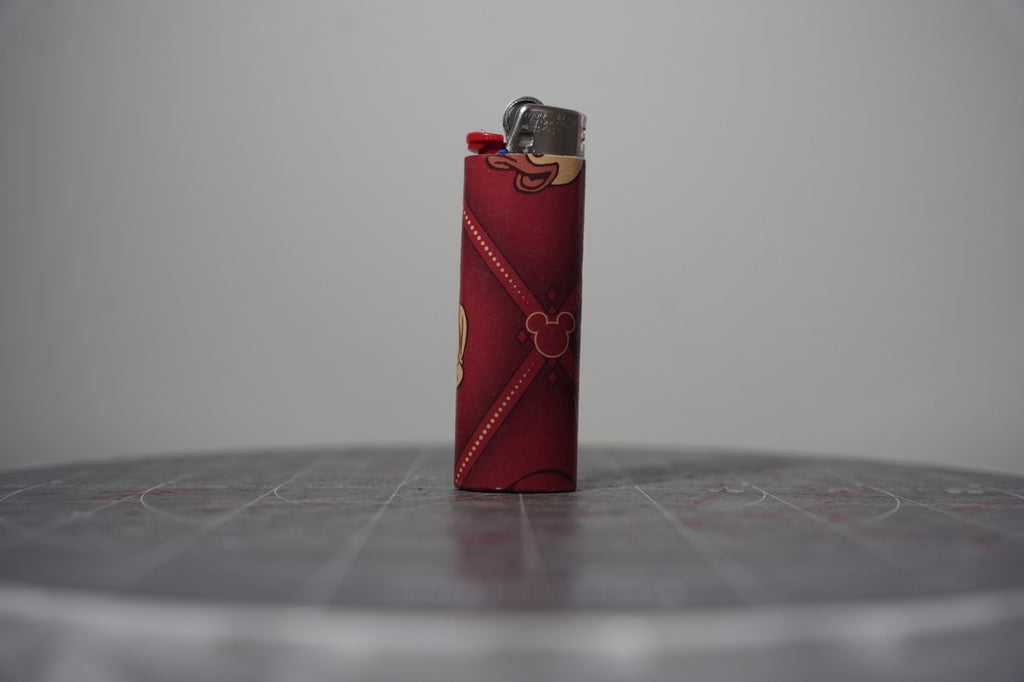 Handmade collage lighter made from vintage Disney comic book paper, dark red diamond pattern with Mickey ear icons