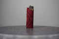 Handmade collage lighter made from vintage Disney comic book paper, dark red diamond pattern with Mickey ear icons