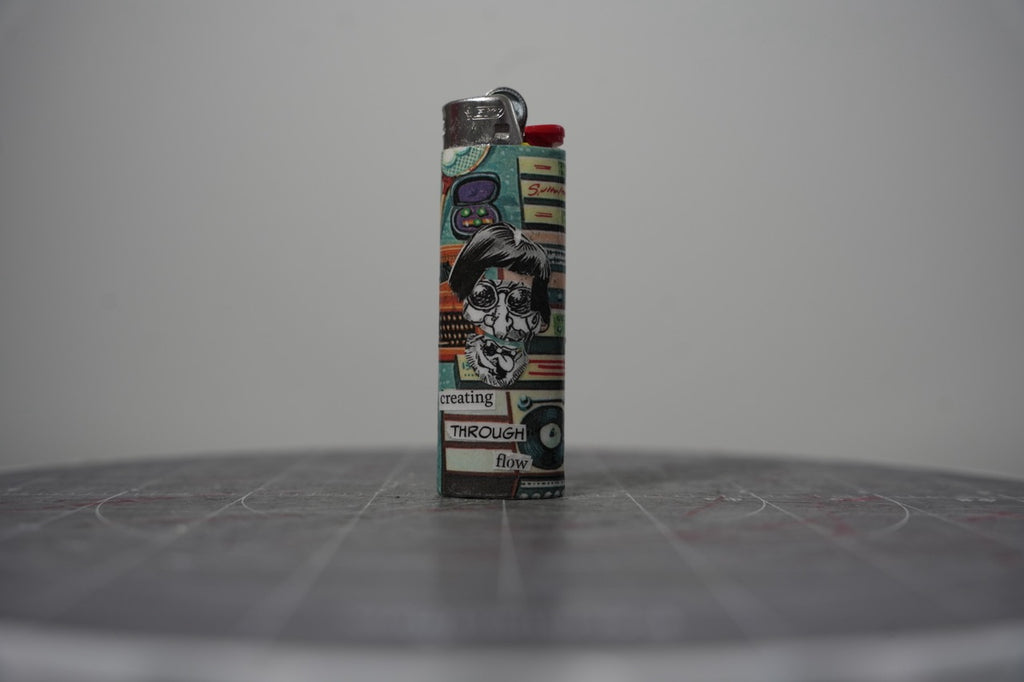 Handmade collage lighter with retro comic appliances and the words creating through flow