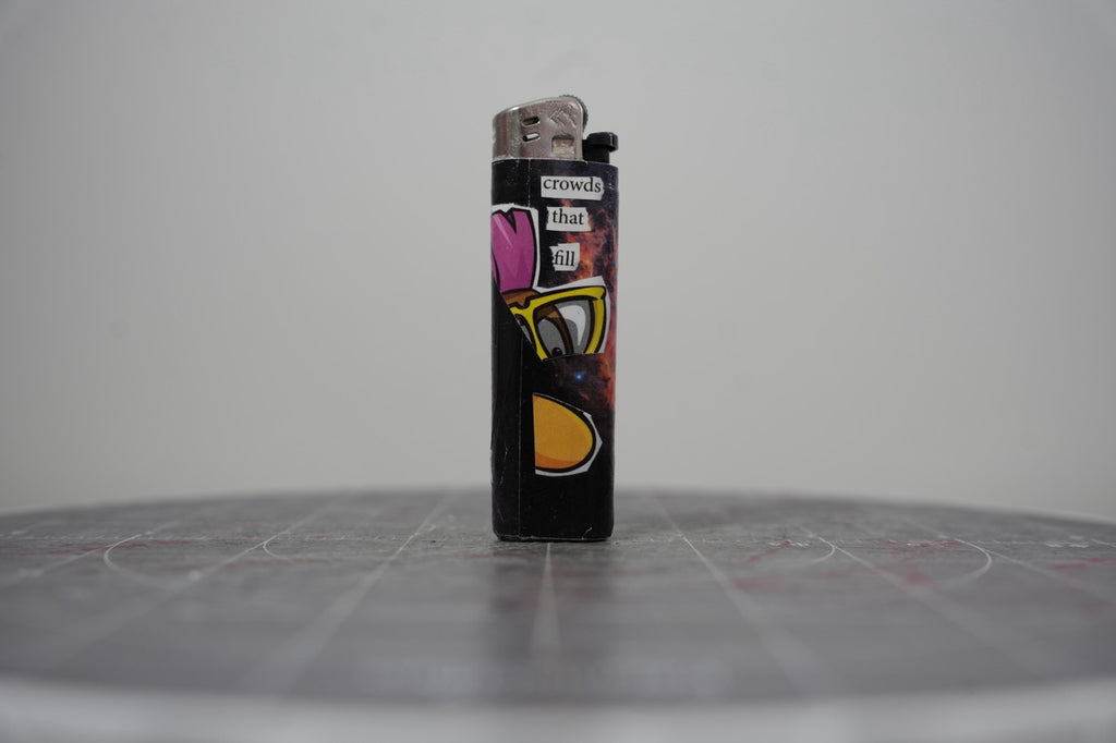 Reverse of the collage lighter showing the words crowds that fill