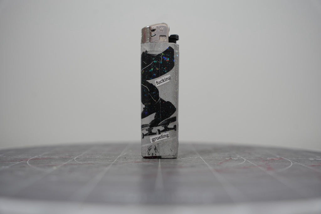 Reverse of the collage lighter showing a skateboarder mid-trick