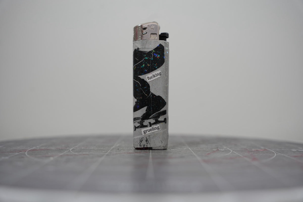 Reverse of the collage lighter showing a skateboarder mid-trick