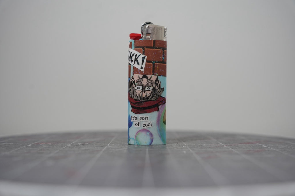 Handmade collage lighter with a brick wall, a man in glasses and a red scarf, and the words it's sort of cool