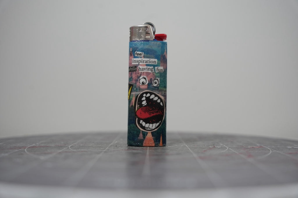 Handmade collage lighter with temples, a big open cartoon mouth and the words feel inspiration while having fun