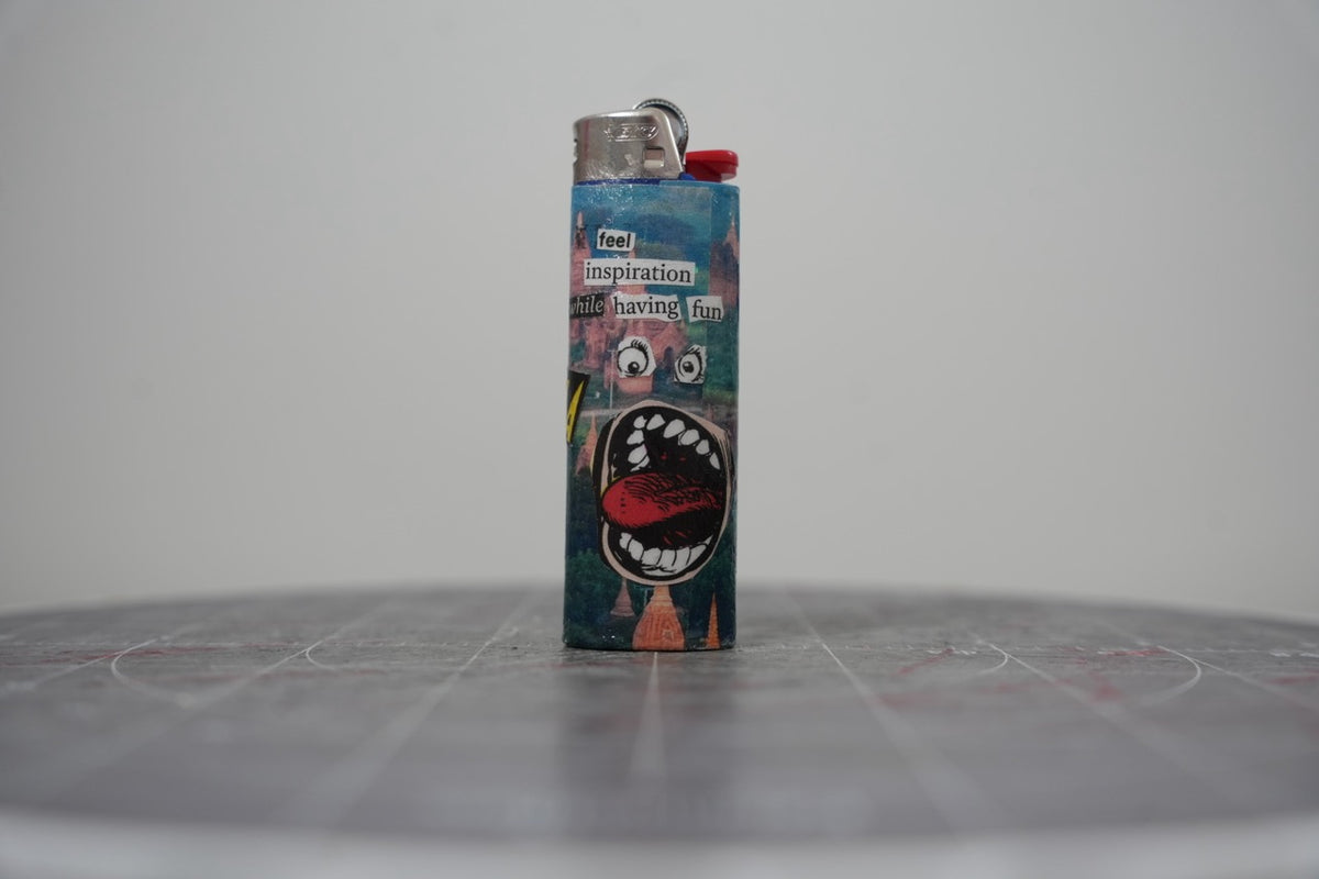 Handmade collage lighter with temples, a big open cartoon mouth and the words feel inspiration while having fun