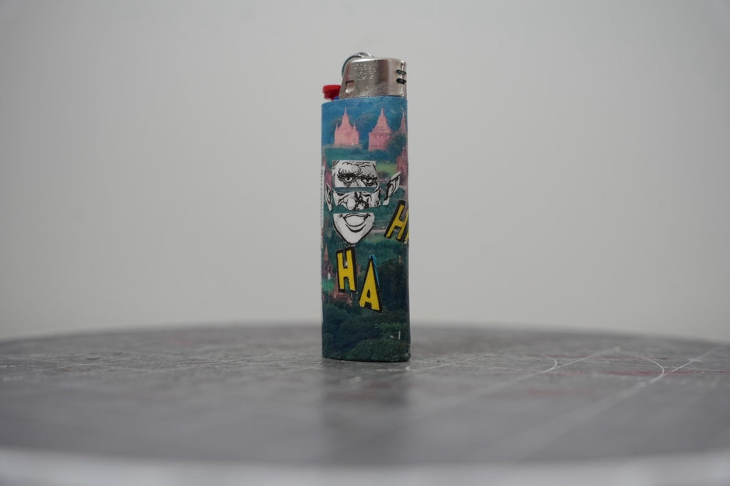 Fourth view of the collage lighter showing the yellow HA HA letters