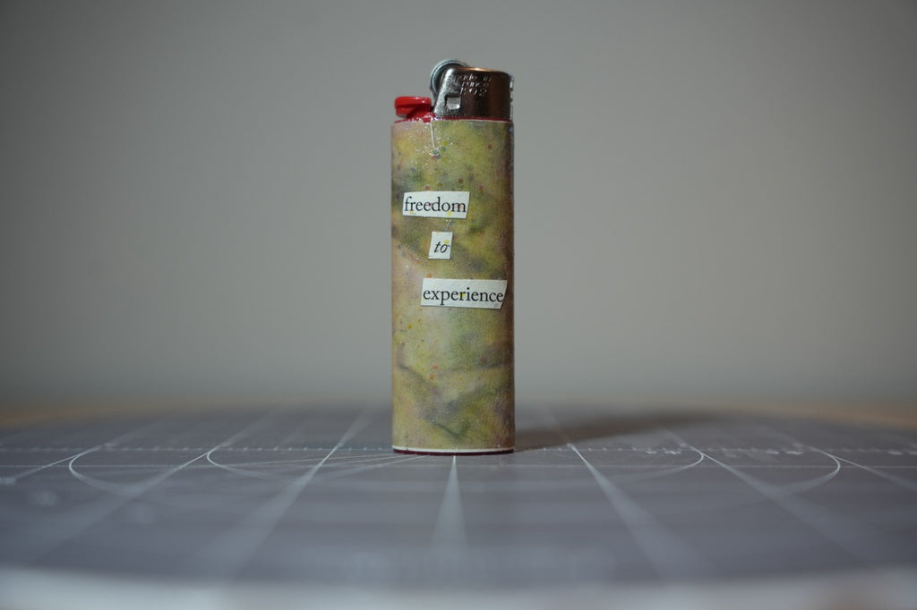 Reverse of the collage lighter showing the words freedom to experience