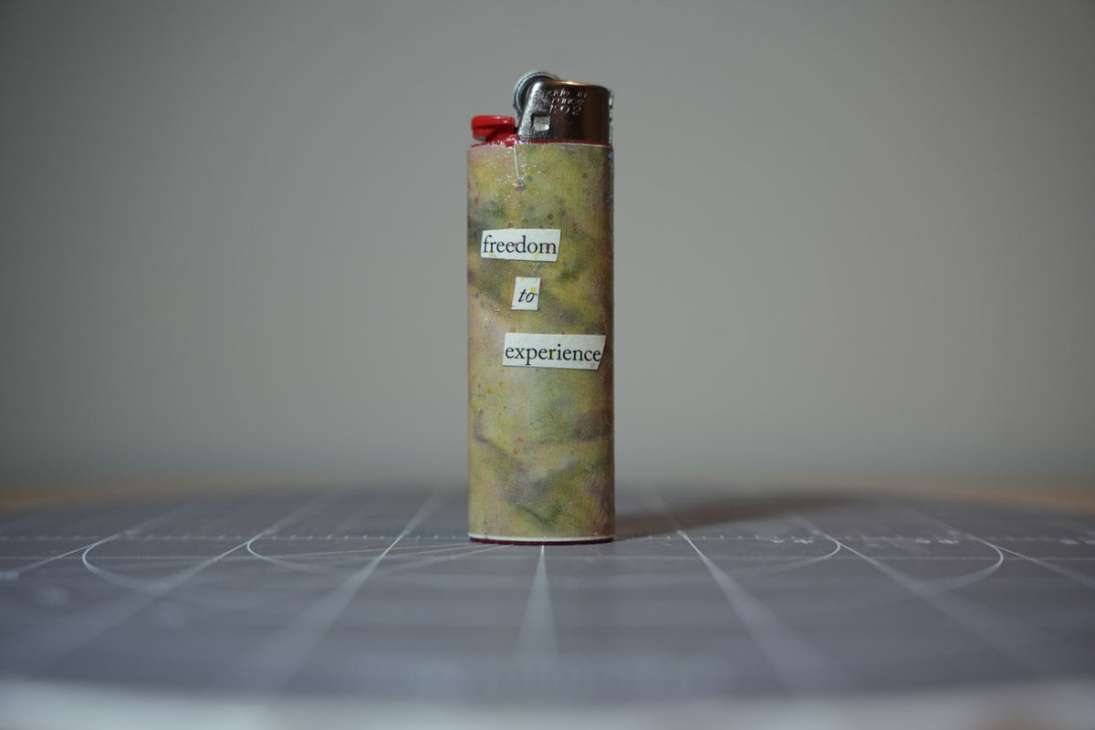 Reverse of the collage lighter showing the words freedom to experience