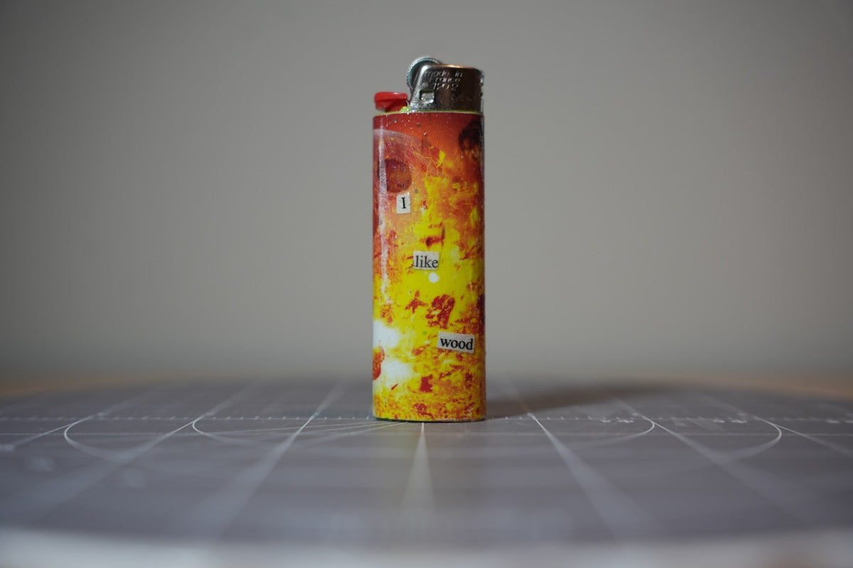 Handmade collage lighter covered in orange flames with the words right into homosexuality