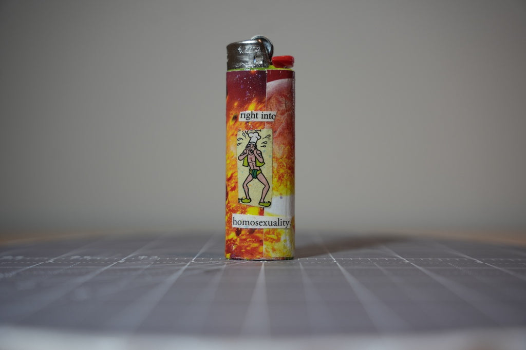 Reverse of the collage lighter showing a cartoon man in a chef's hat and the words I like wood